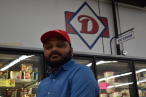 Dhru Patel, co-owner of Mr. D's Delicious Fresh Foods, is shown with the Mr. D's logo behind him.