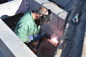 A welder for Jet Excavating works on the new Orangeville Road Bridge.