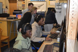 Ta'-Hari Wester, foreground, and Christian Davis are members of the Brookfield High School esports team. Club advisers, back left, are Josy Kirila Chu and Tim Reinsel.