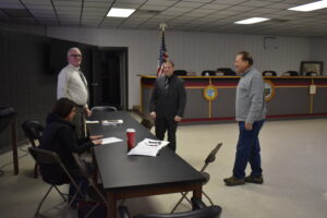 Brookfield Police Sgt. Aaron Kasiewicz, in suit, is shown before his interview for the police chief's position with township trustees, from left, Shannon Devitz, Dan Suttles and Mark Ferrera.