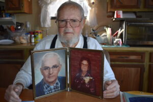 John Schultz is shown with a photo of his parents, Rhinold and Alice Schultz, who were instrumental in the early days of the Brookfield Township Fire Department.