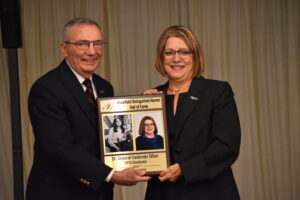 Deborah Vasbinder Dillon received her Brookfield Distinguished Alumni Hall of Fame plaque from Dan Deramo.