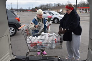 Brookfield senior citizens van driver Dorothy “Dori” Yez, right, helps Shirley Ferenczy load her groceries into the van.